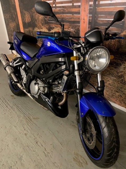 blue motorcycle semi side view