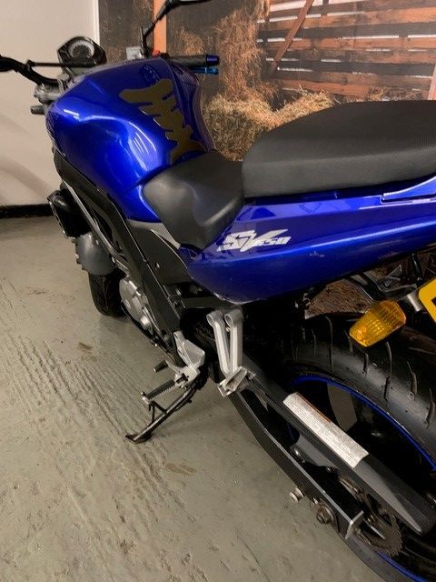 blue motorcycle focus on rear 